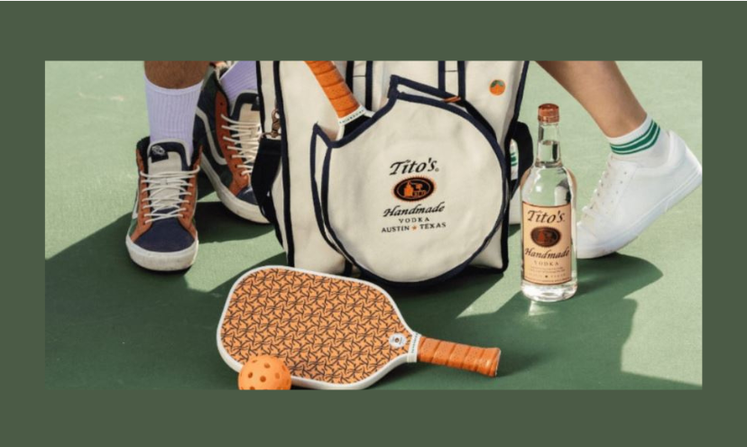 The image shows Titos vodka and pickleball accessories near two player's feet.