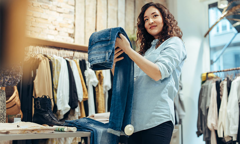 Woman holding a pair of jeans in a store 