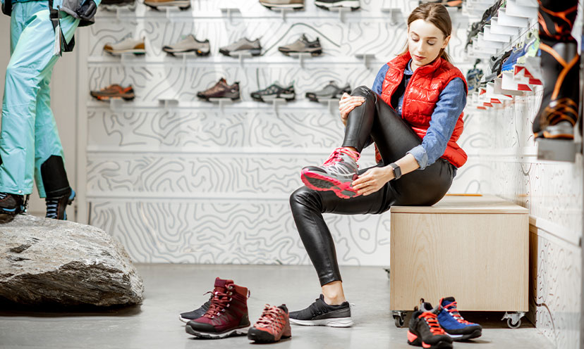 Woman trying on tennis shoes at a store 