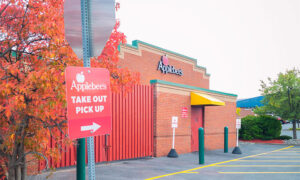 An Applebee's restaurant with a Take Out Pick Up order sign